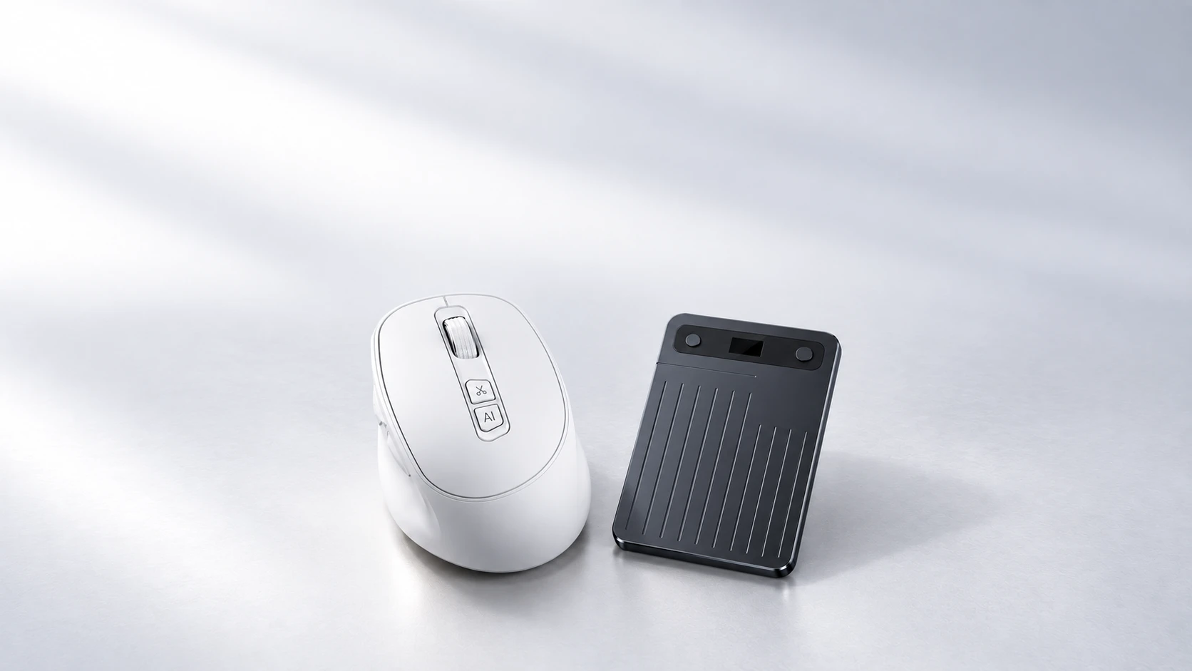 White M2 mouse and A5 recording card in soft silver lighting, showing their bodies and buttons from above